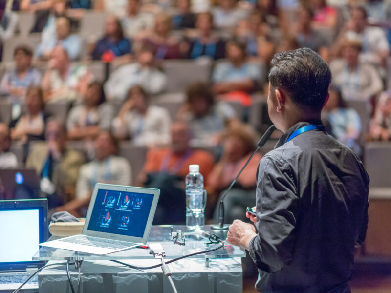 Speaker,Giving,A,Talk,On,Scientific,Conference.,Audience,At,The